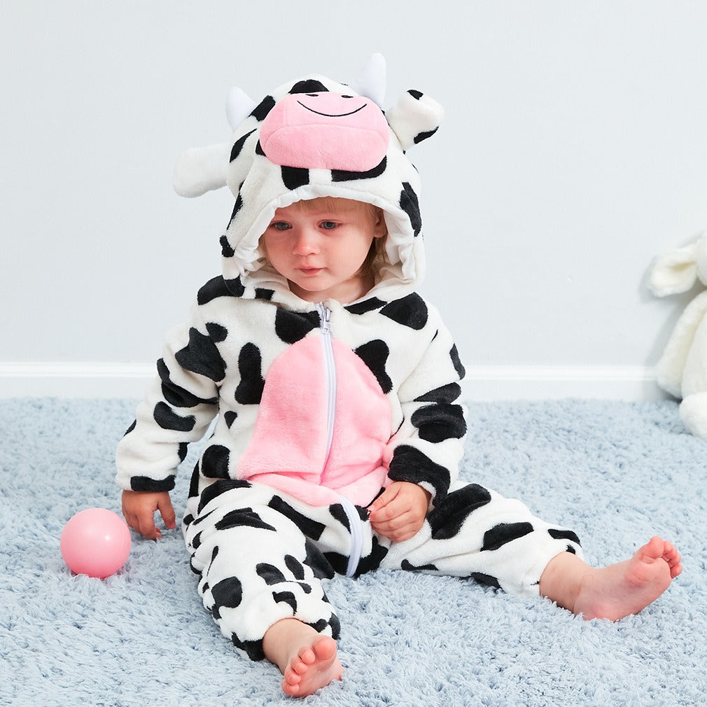 Close-up of split leg design on cow-themed baby jumpsuit for ease of movement.