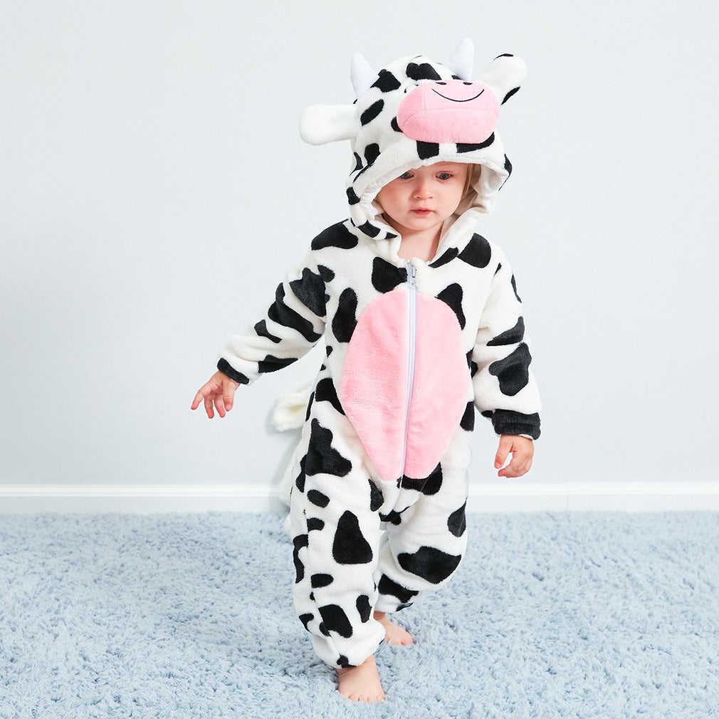 Baby lounging in soft, breathable cotton pajamas with fun cow-themed design.