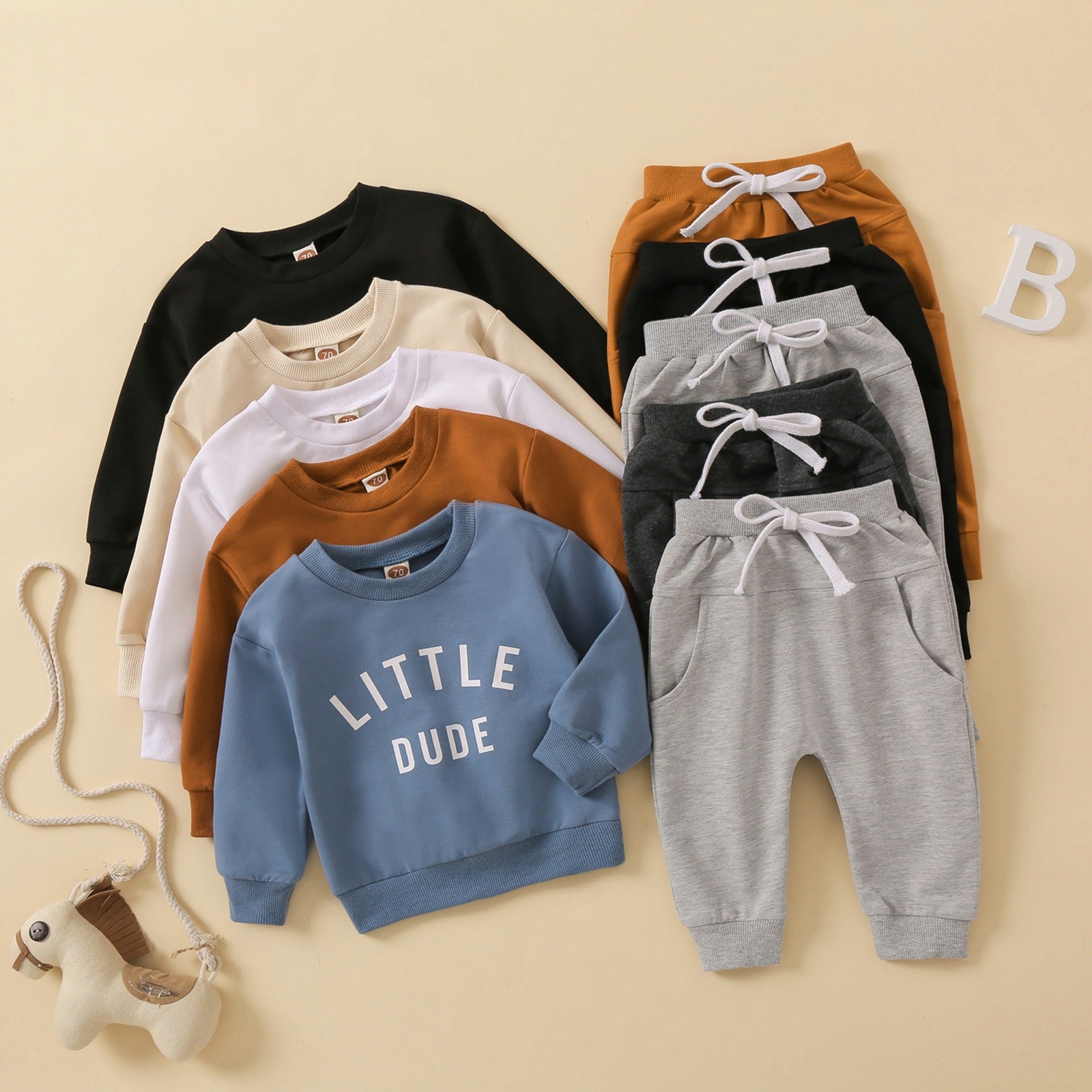 Children's Clothes In Beige Background