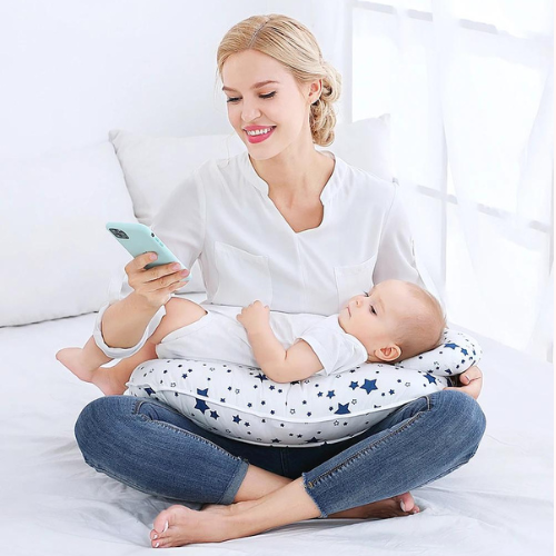 Mom Carrying her baby in the pillow while looking at the phone